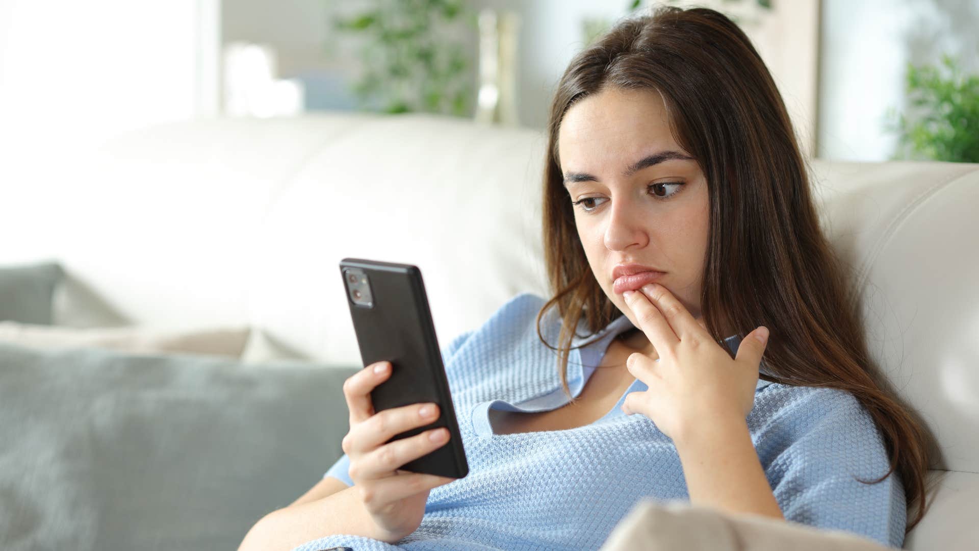 Woman texting "Why would you think that?" on her phone.