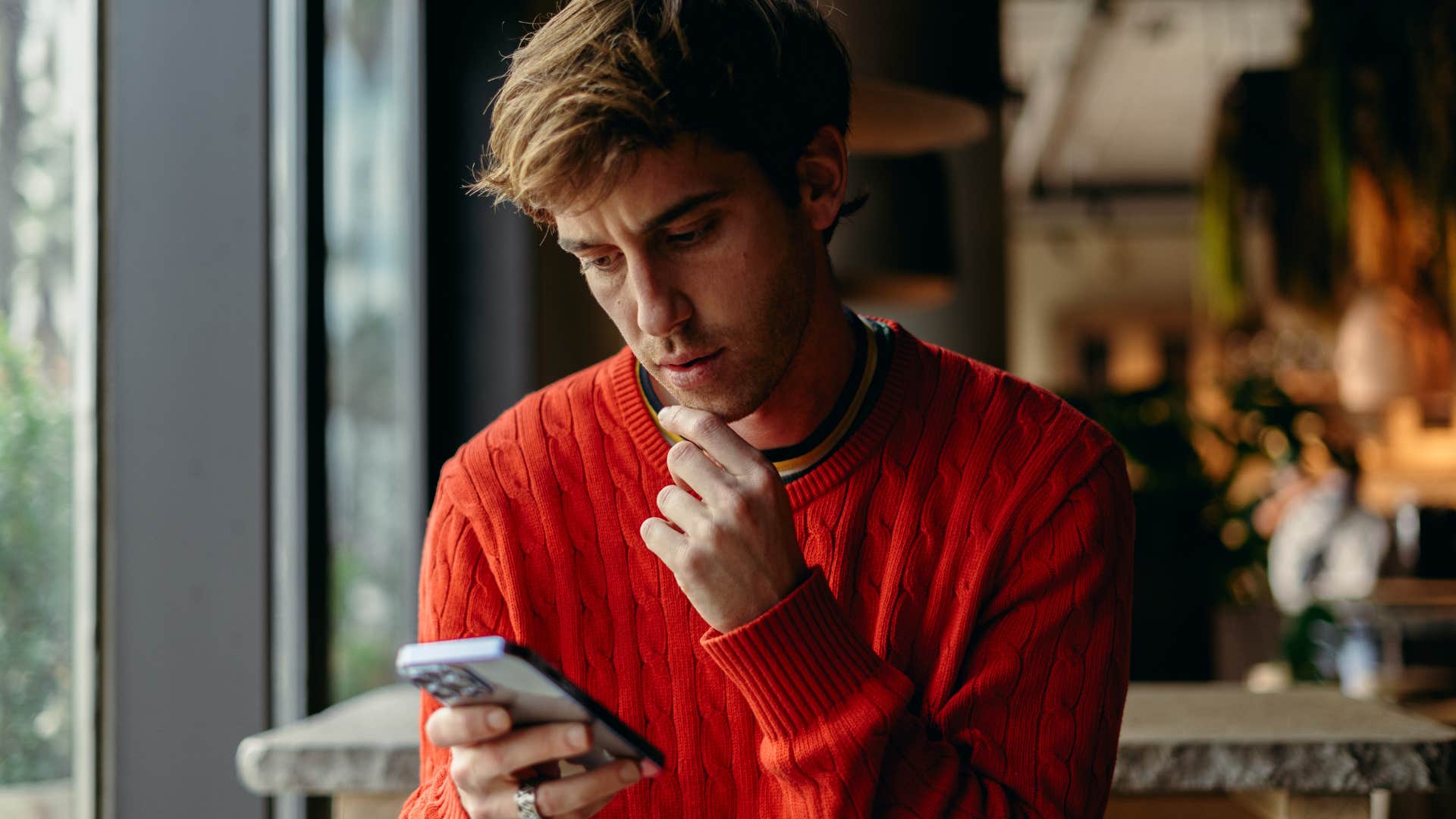Man texting "wow" on his phone.