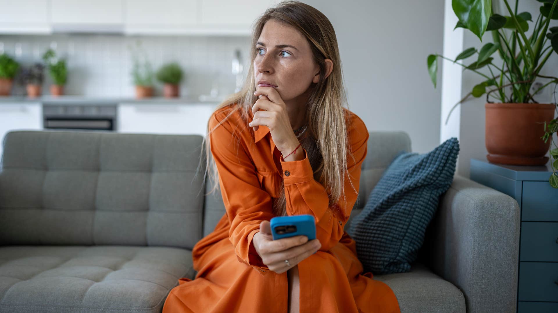 unhappy woman texting on her phone