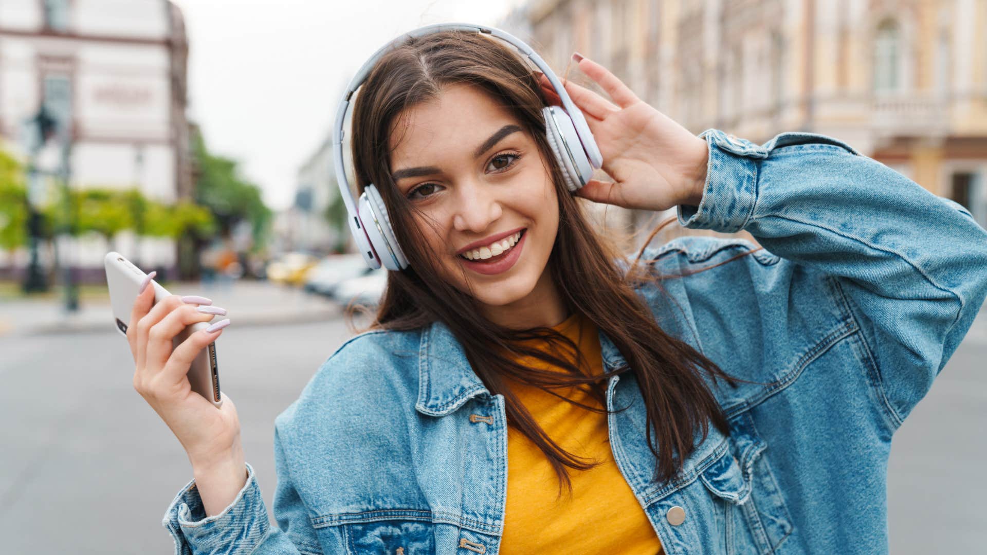 if you do these things on a regular basis you're a better person than you think youre optimistic happy optimistic young woman listening to music outside