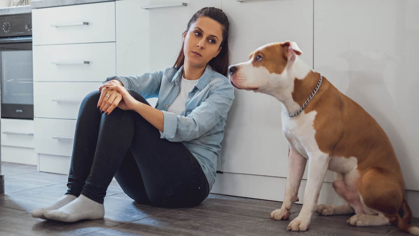 woman upset looking at dog