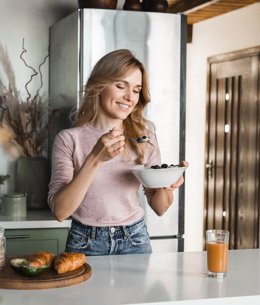happy woman eating healthy food in winter