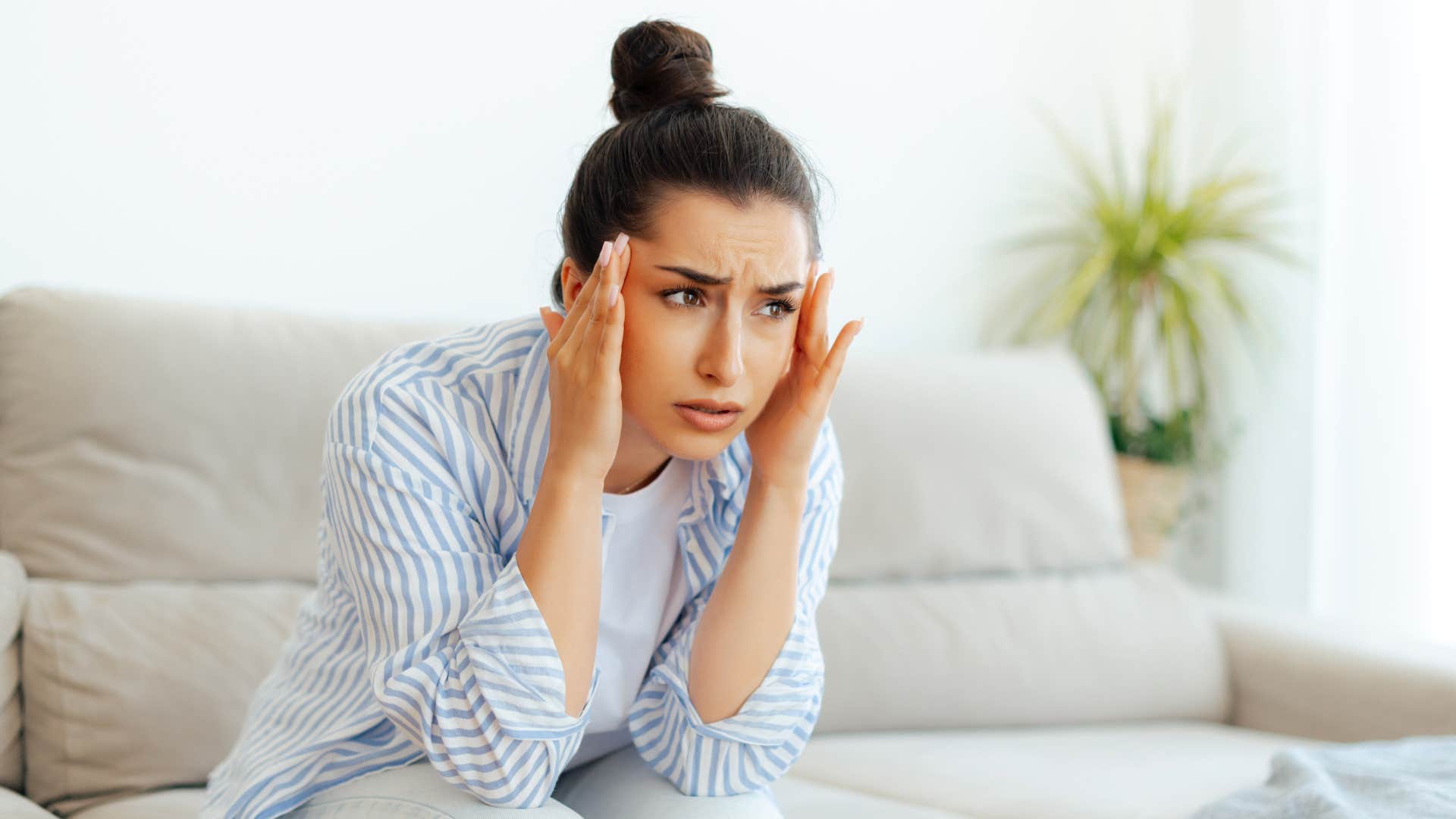 woman who has a migraine with the symptom of blurry vision