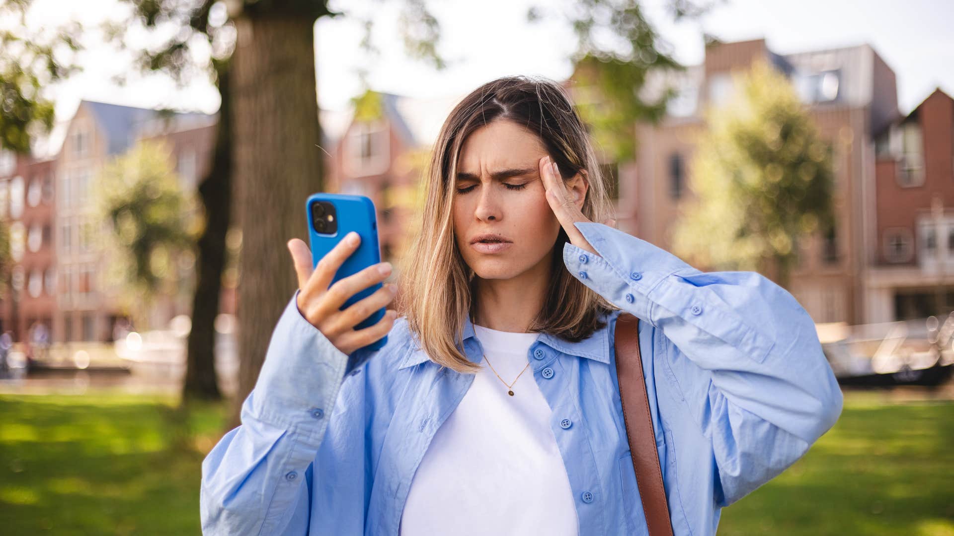 woman looking at social media post on her phone