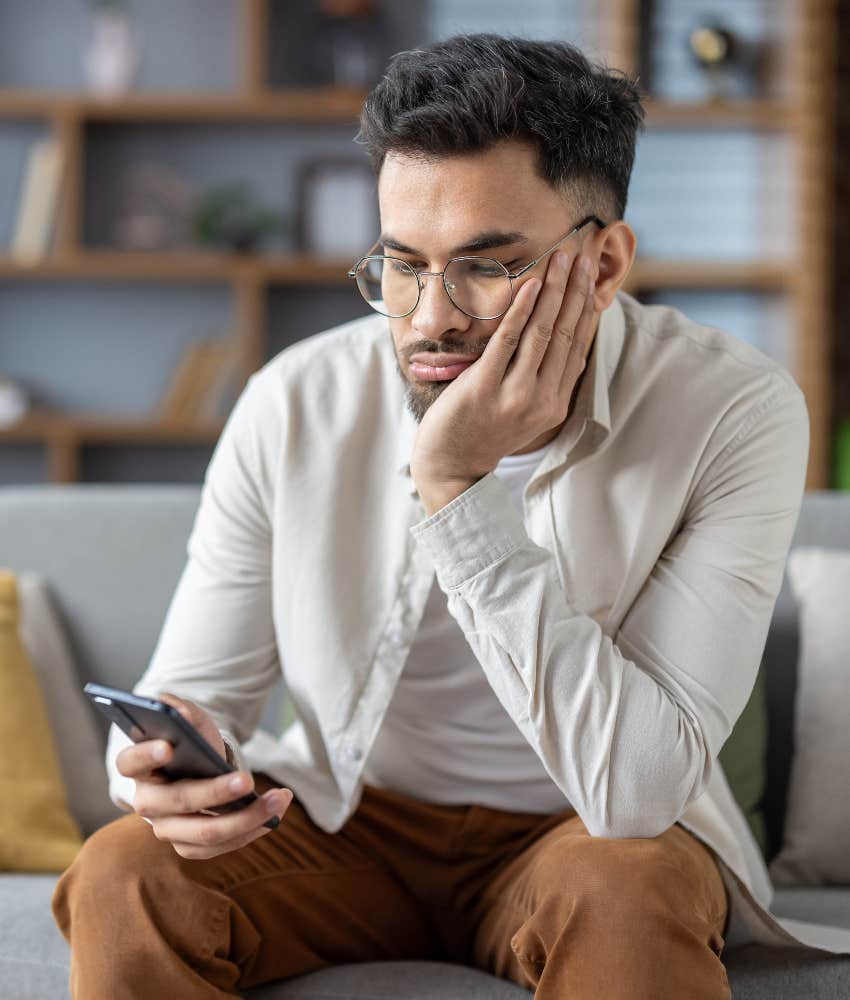 man feeling bored looking at phone