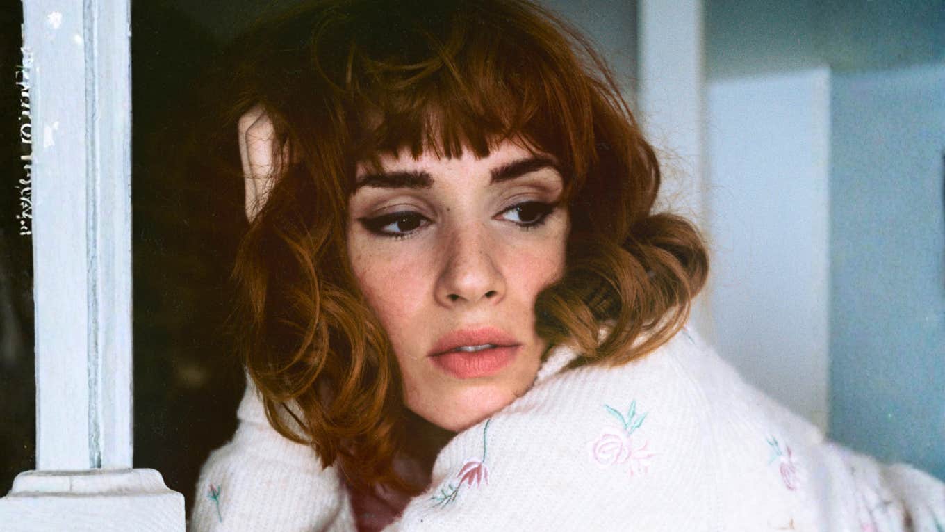 Bored woman staring off thoughtfully, symbolizing emotional emptiness and the quiet realization that something’s missing in her relationship.