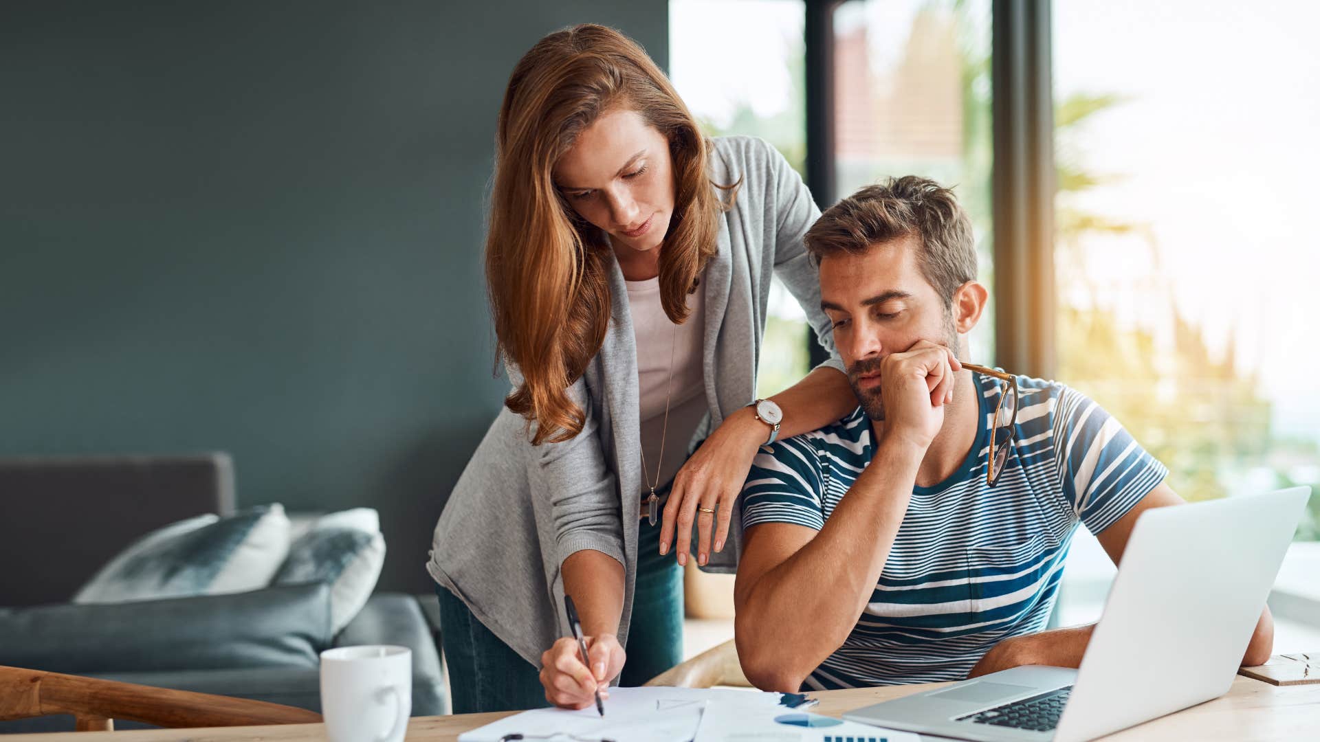 couple handling unexpected expenses on laptop