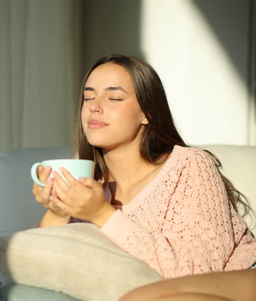 woman soaking up sunlight outside in the morning