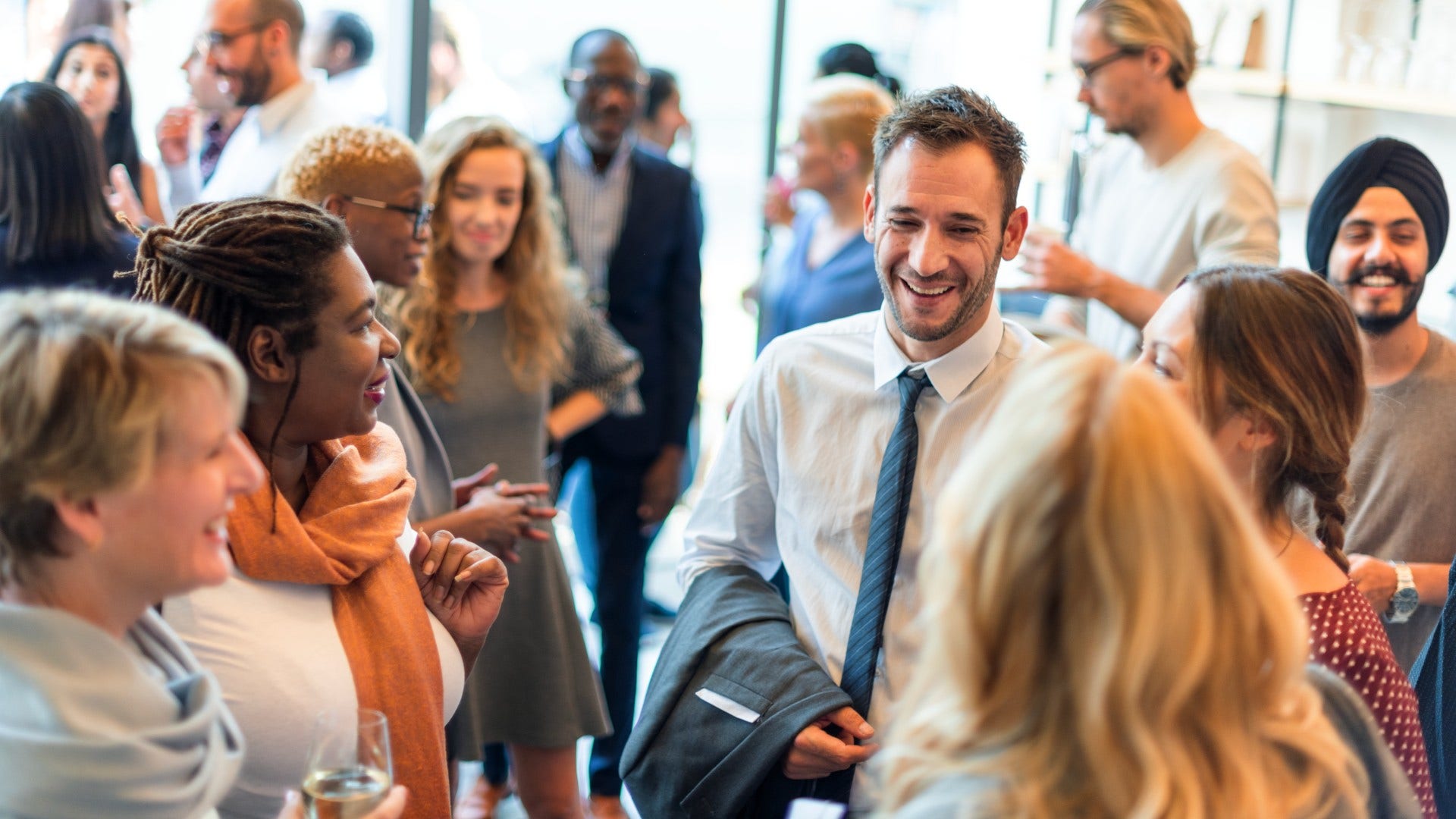 man who is over tinder as he tries to meet women at networking event