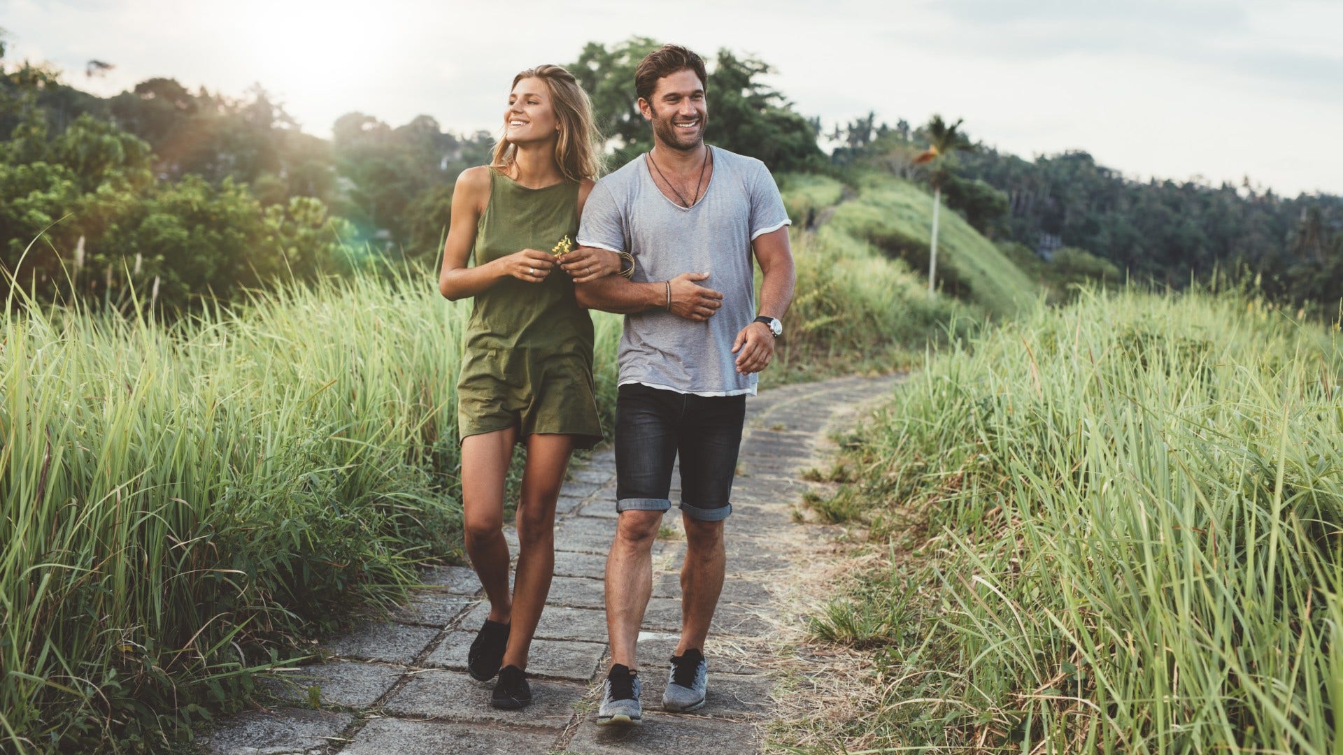 man who is over tinder as he meets woman strolling through park