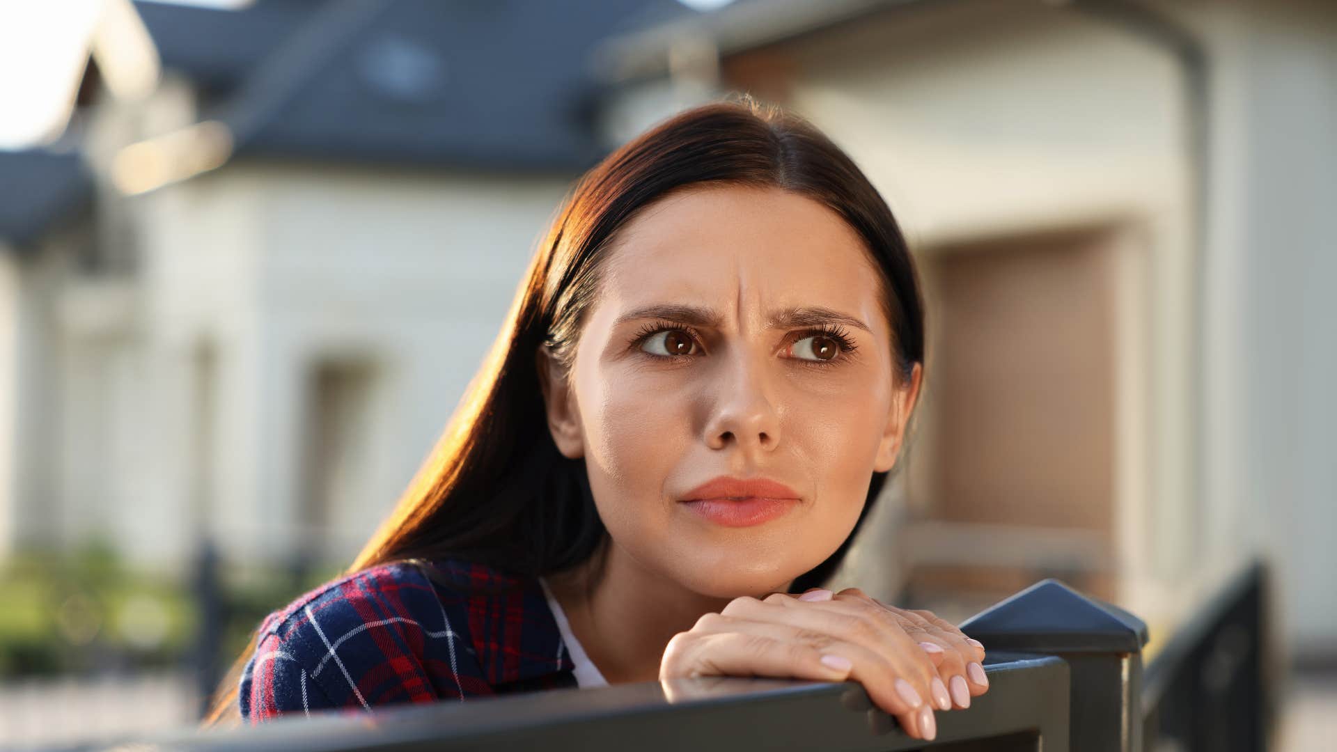 woman looking over fence as she instantly notices small changes in people's behavior