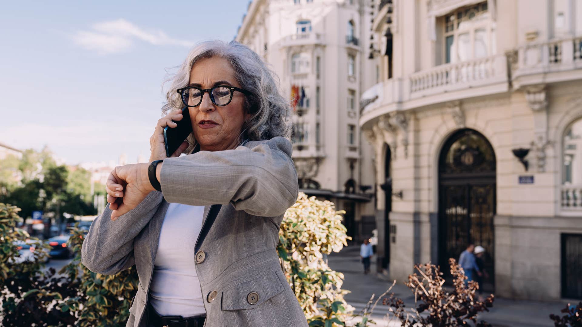 woman looking at watch as she never asks for help