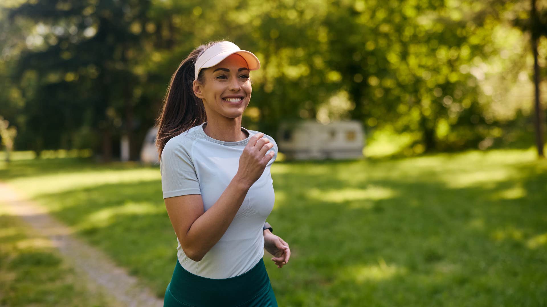 woman sets up small personal challenges for herself as she jogs and smiles