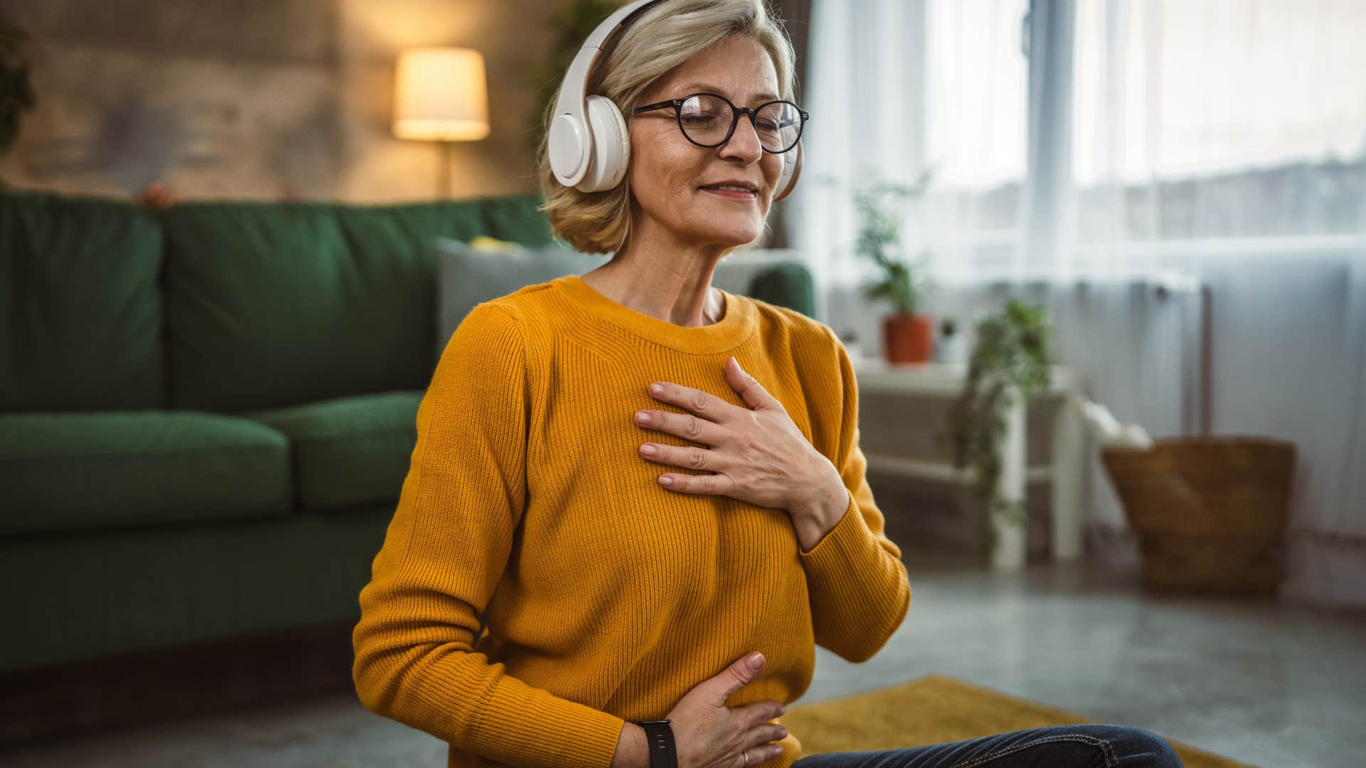 woman manifesting while wearing headphones