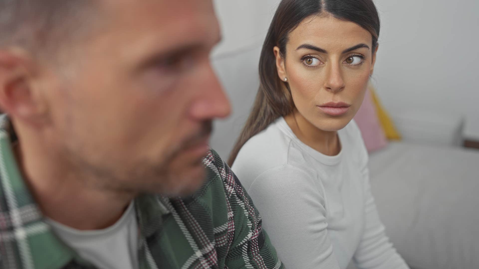 Man saying "I don't want to talk about it" to his wife.