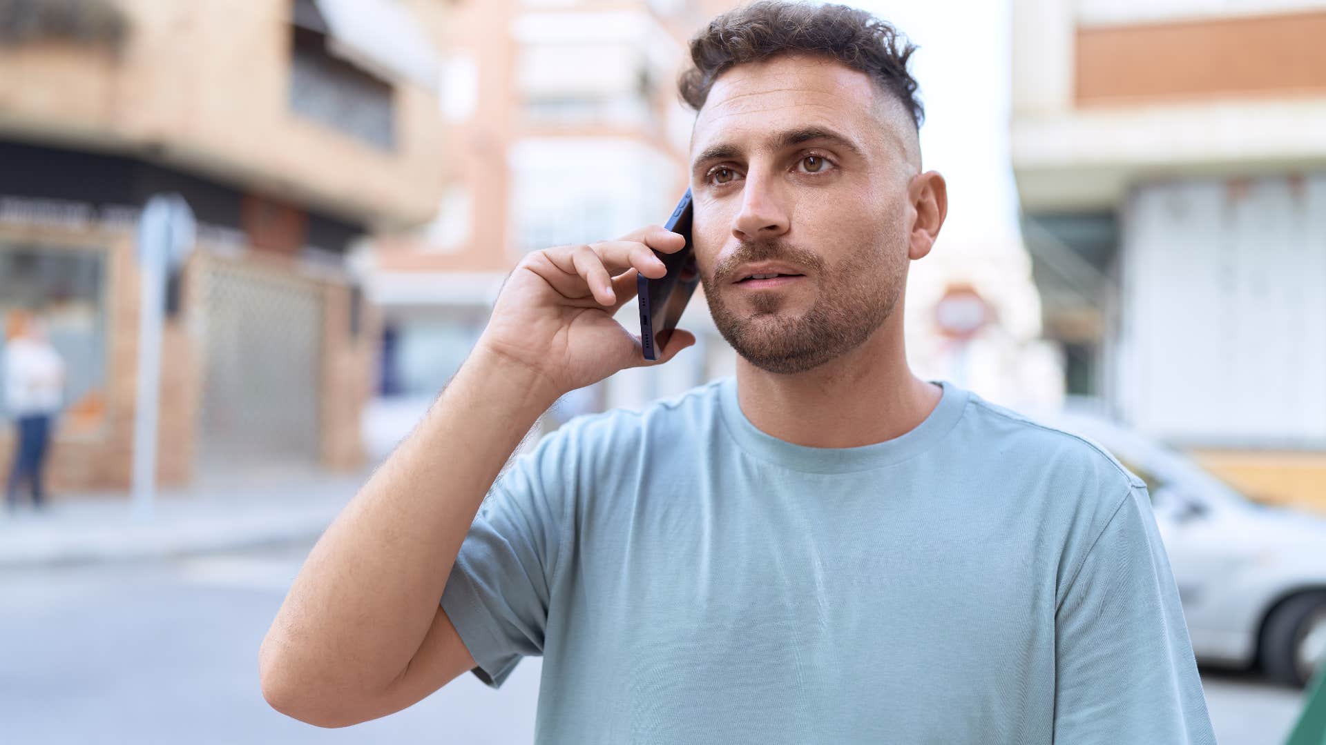 Man saying "I'll be home late" on the phone.