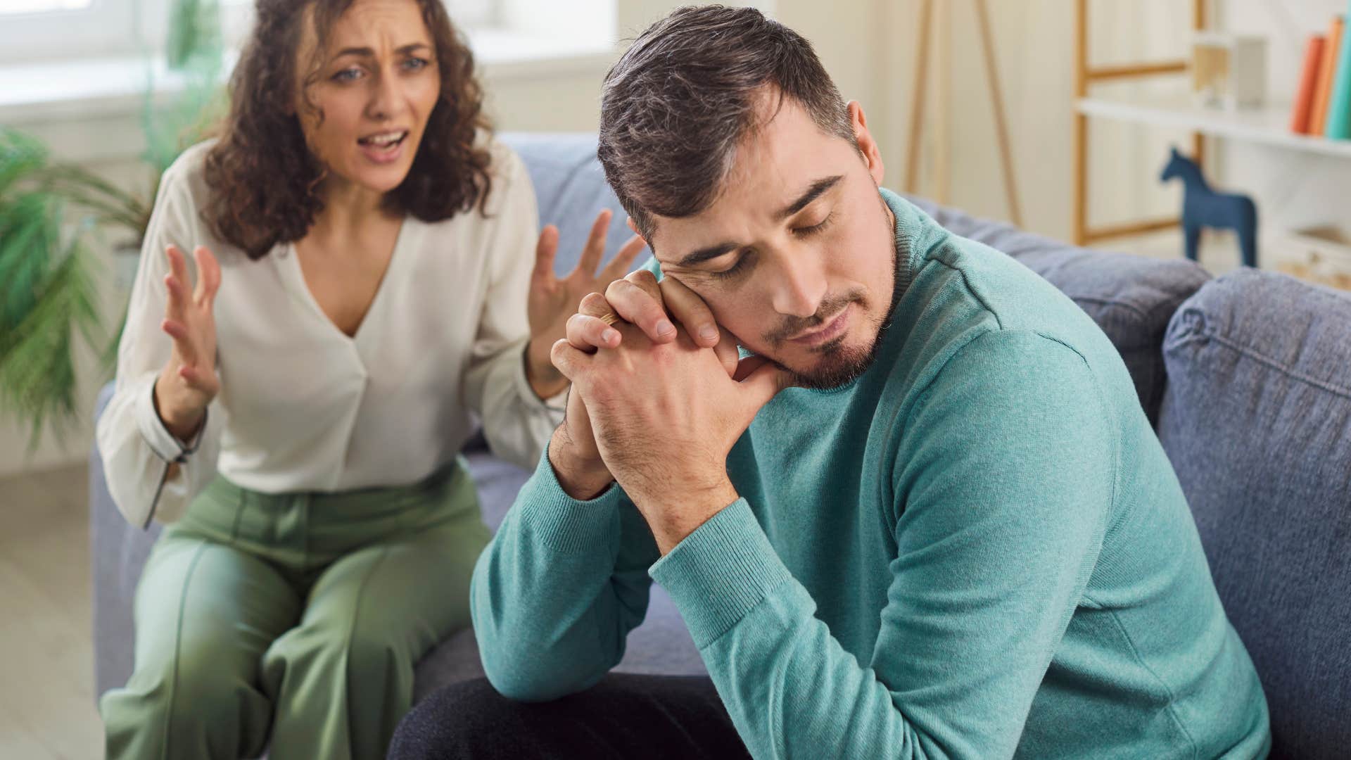 man thinking I'll just do it myself with wife yelling at him