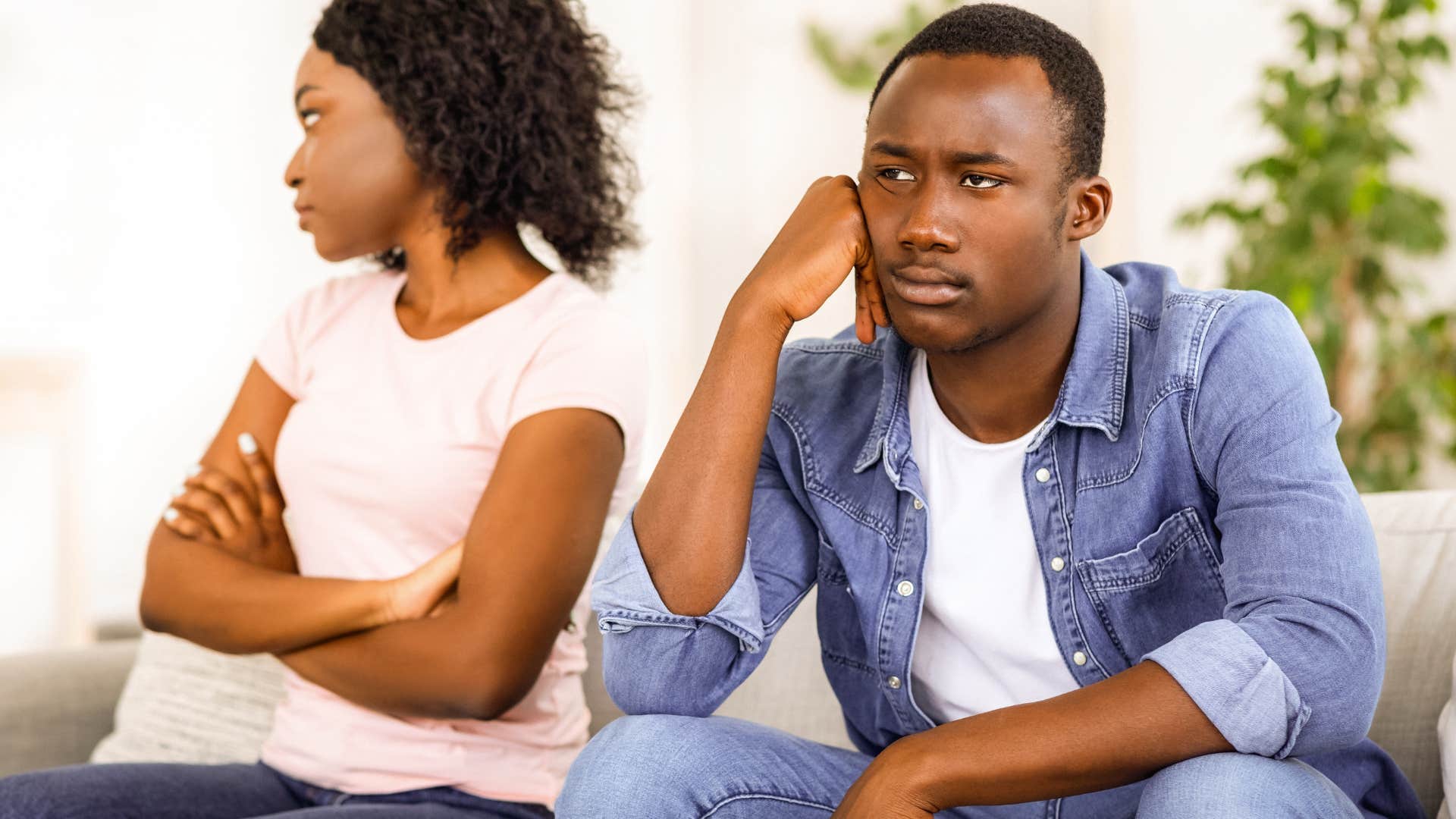 man saying I'm fine sitting next to his upset wife