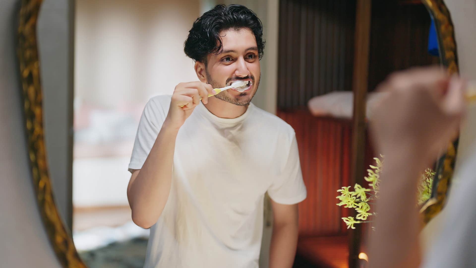 man doing his nighttime routine brushing his teeth