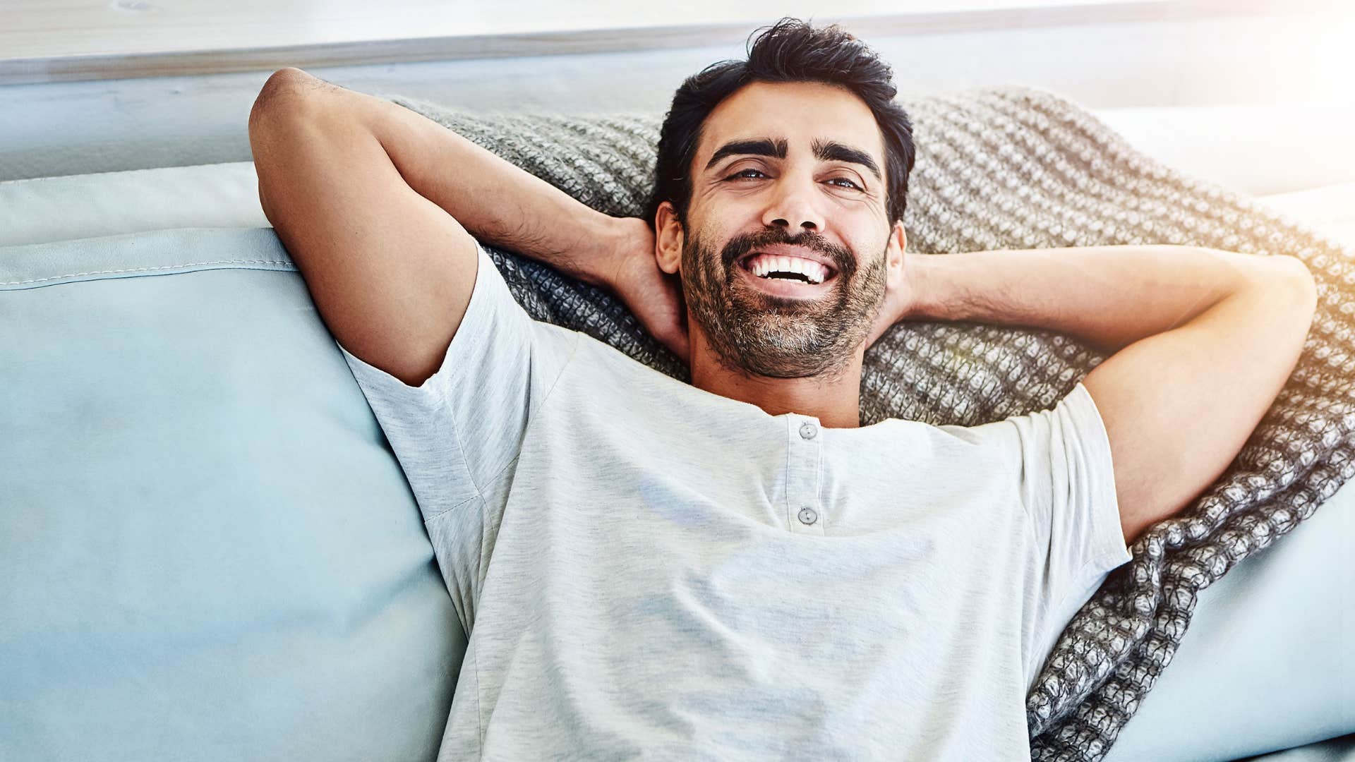 man who's physically more comfortable alone laying on the couch