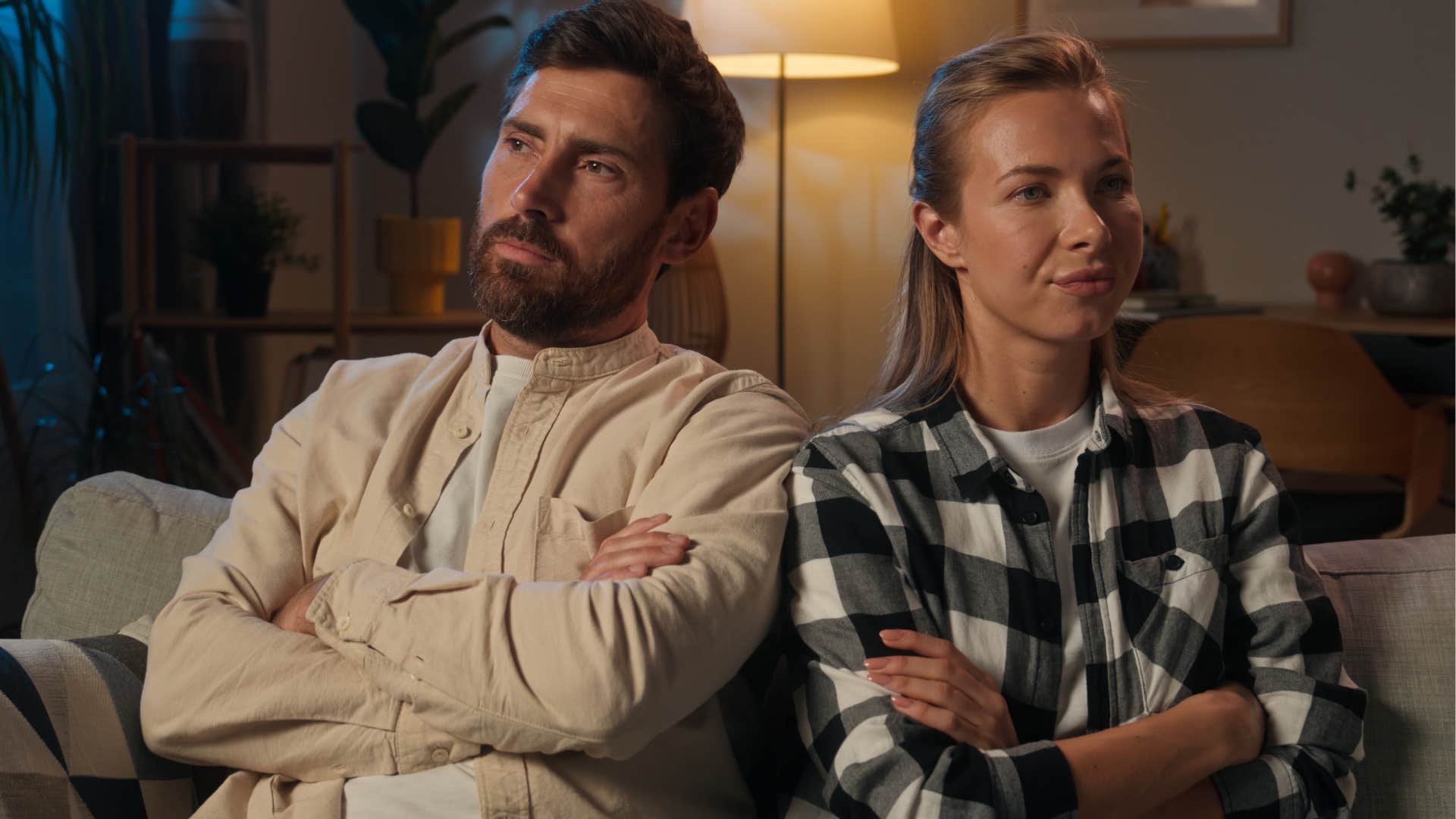 man sitting with his wife tired of fighting before bed