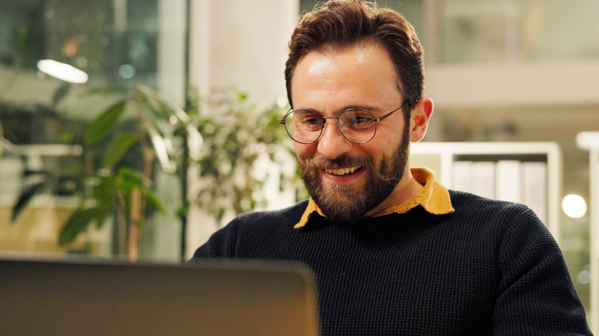 man who works a different schedule smiling in an office