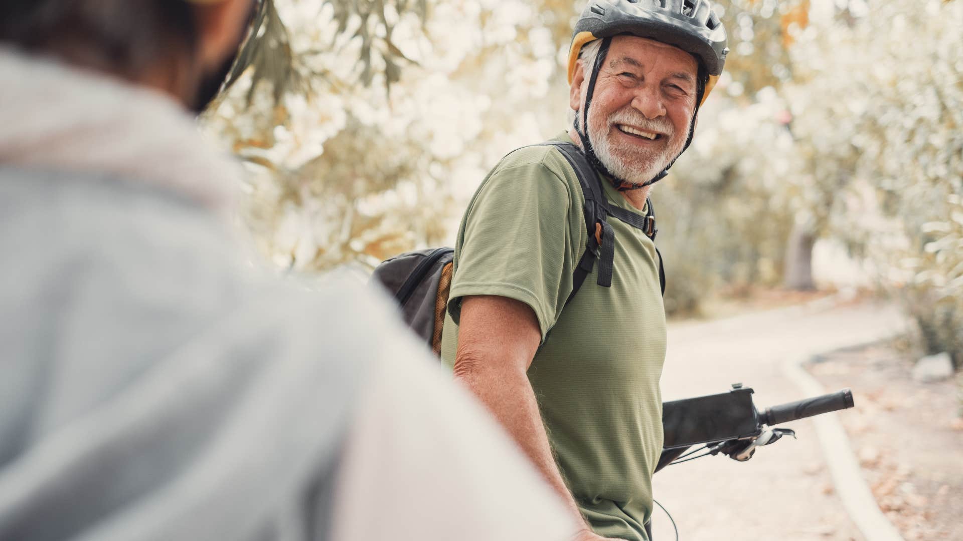 two men riding bikes outside together 
