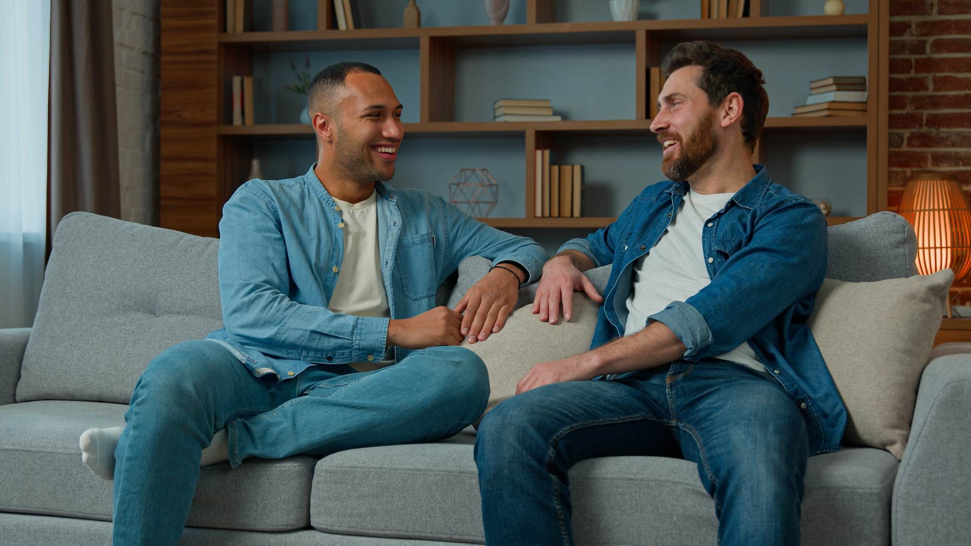 two men having conversation on sofa