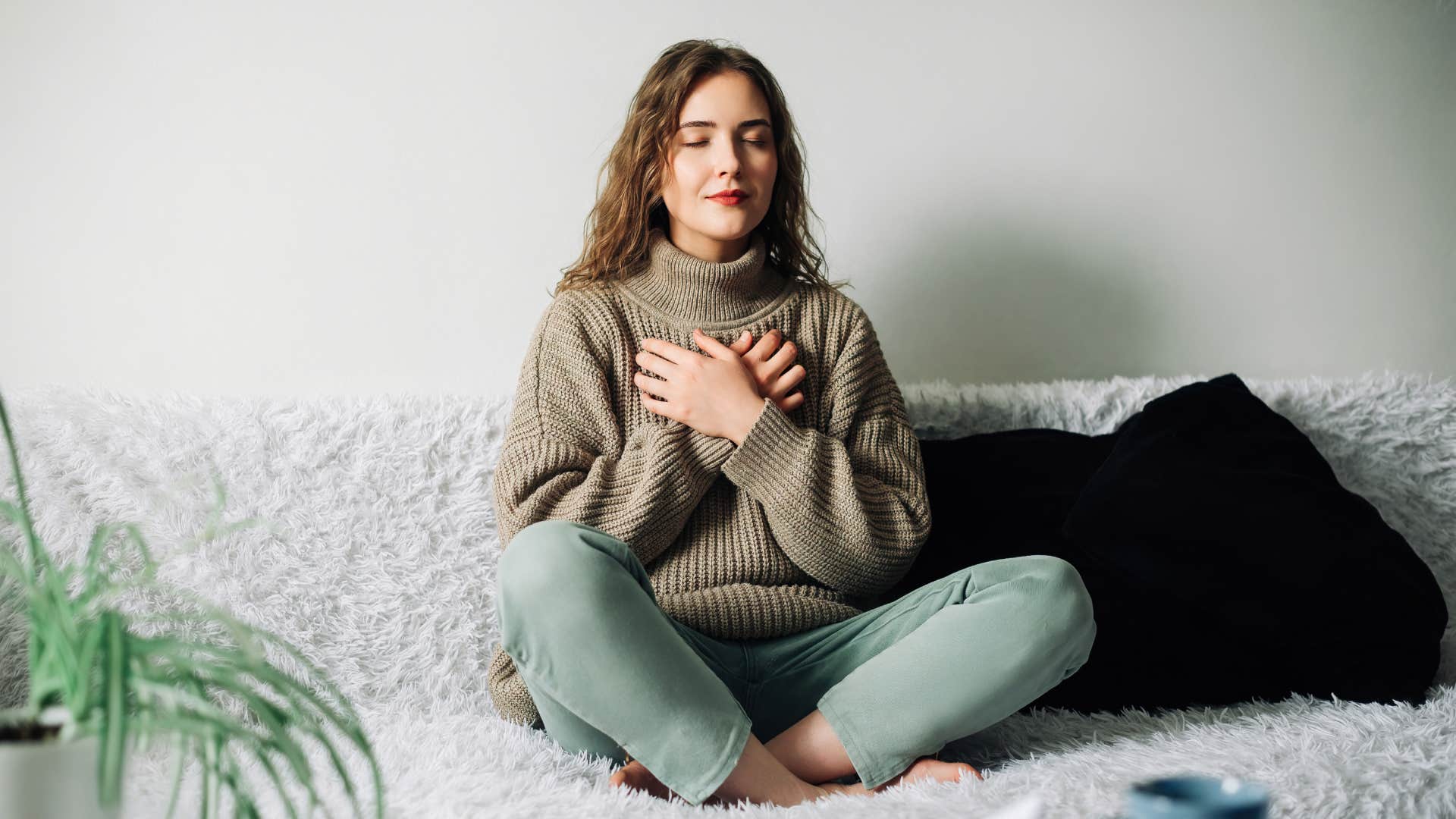 woman relaxing on bed meditating