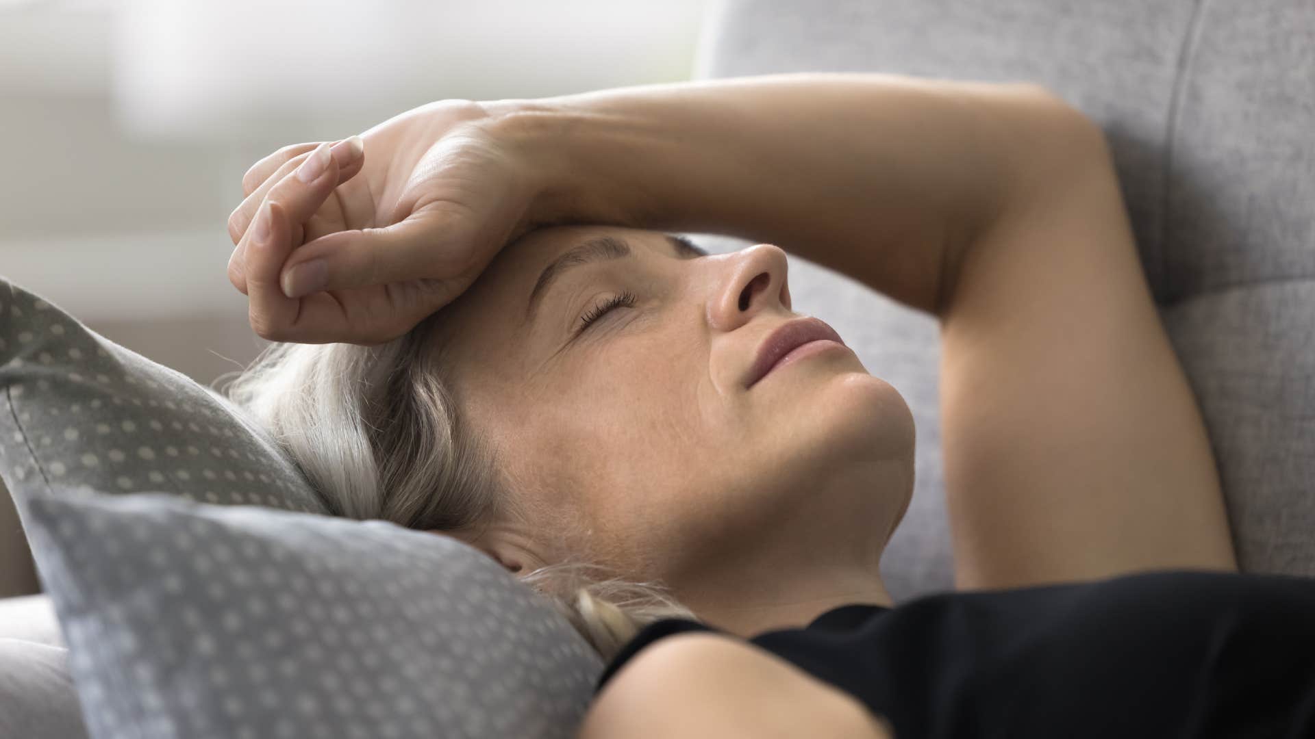 woman sleeping on couch feeling independent