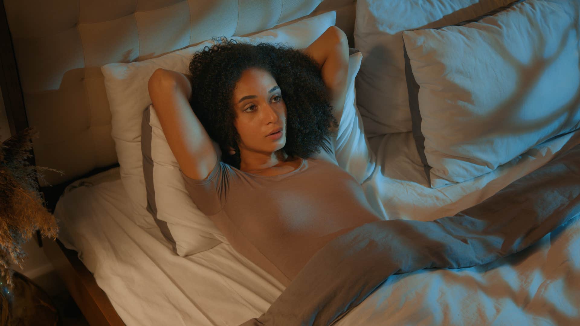 woman overthinking in bed