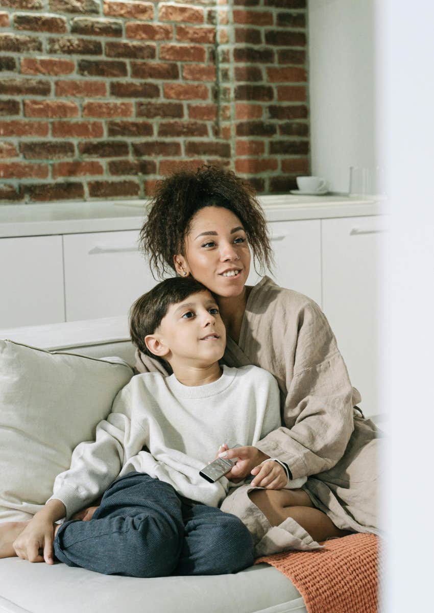 mom watching TV with her young son
