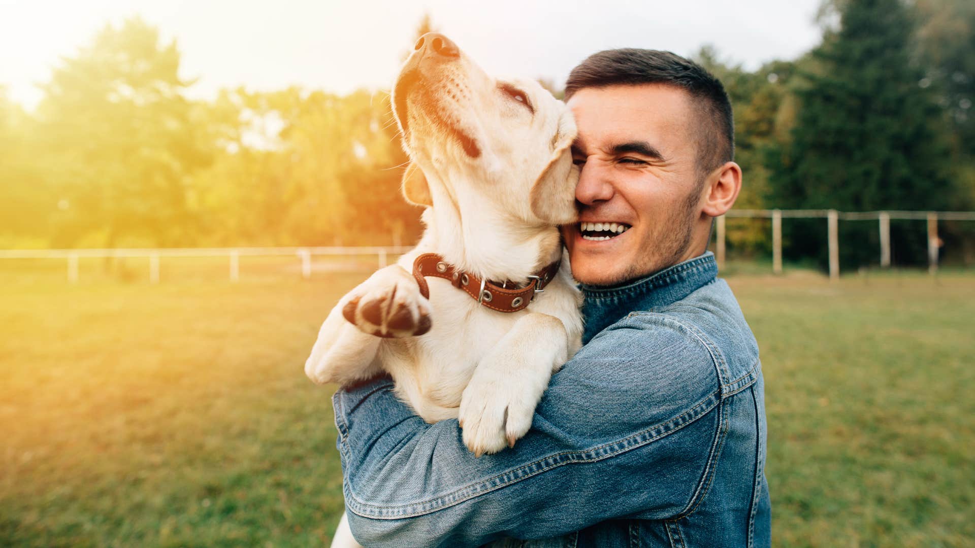 authentic man happily hugging his dog