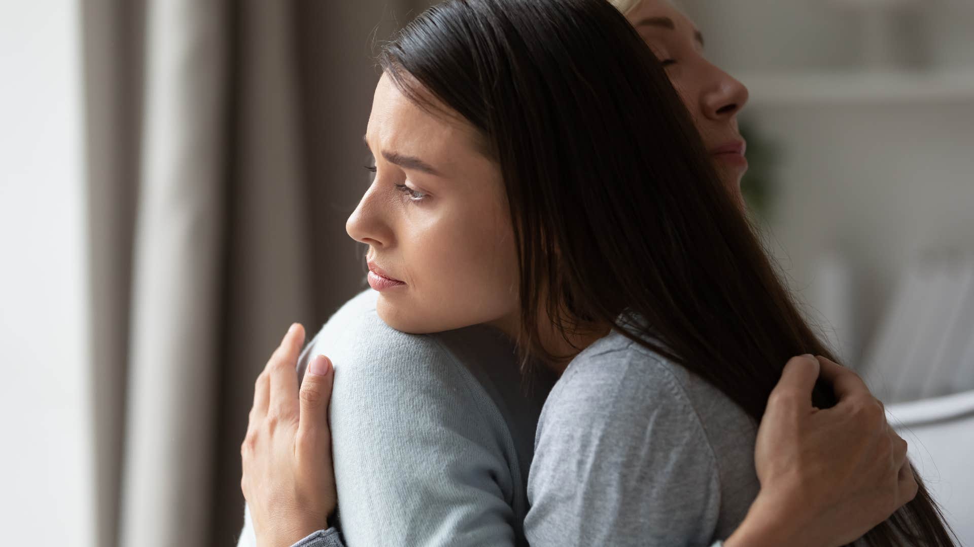 woman controlling emotions embracing mom