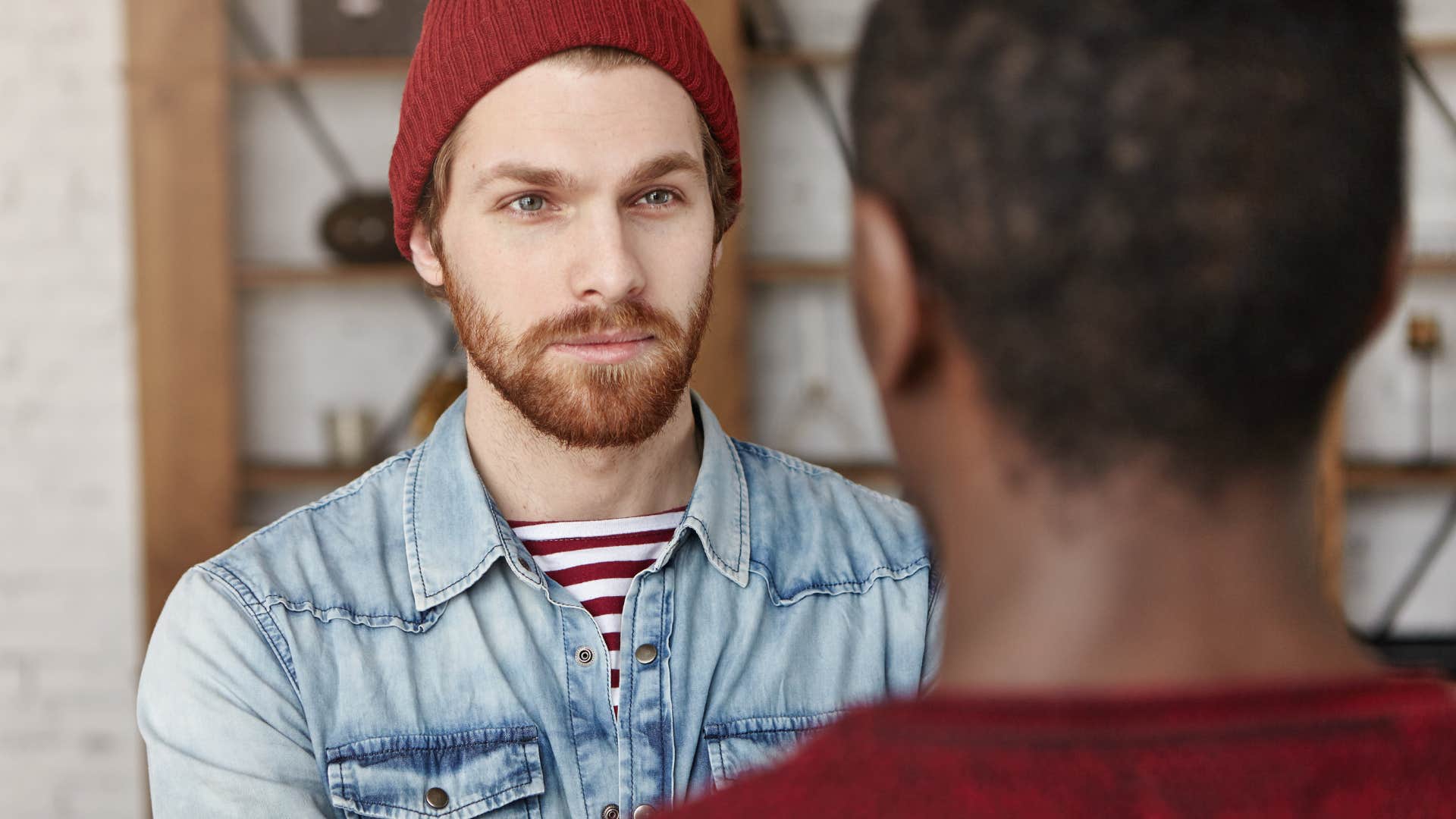 watchful man listening intently to friend