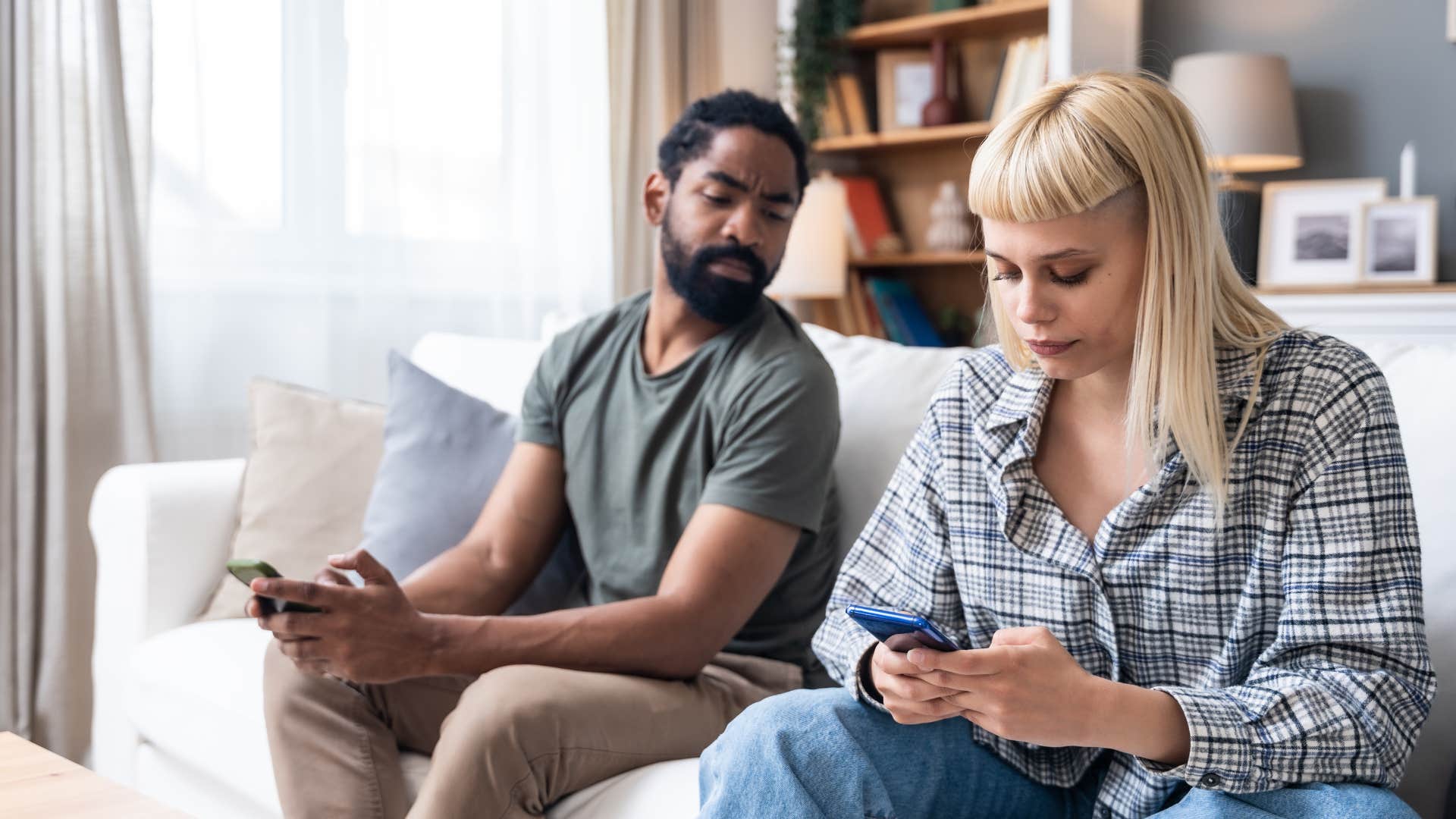 if someone can't stop doing these things they're probably more controlling than they even realize peering at people's phones controlling man peering at woman's phone