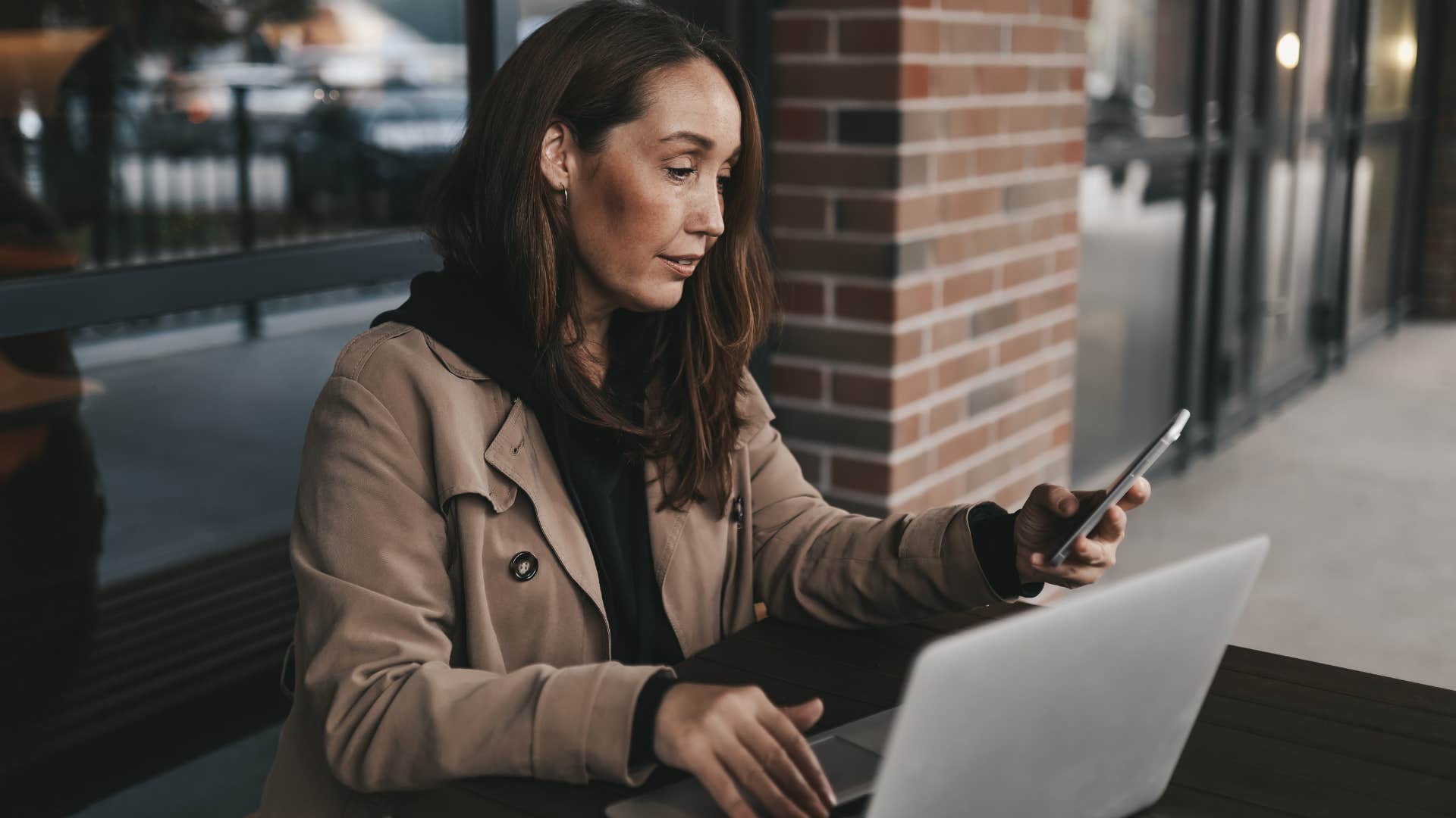 Woman checking her bank account before paying on her phone.