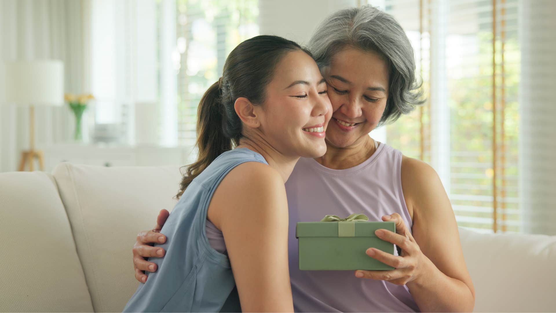 Woman who gives practical gifts hugging her mom.