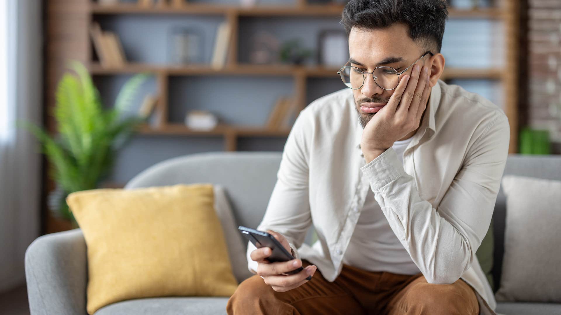 upset man looking at his phone