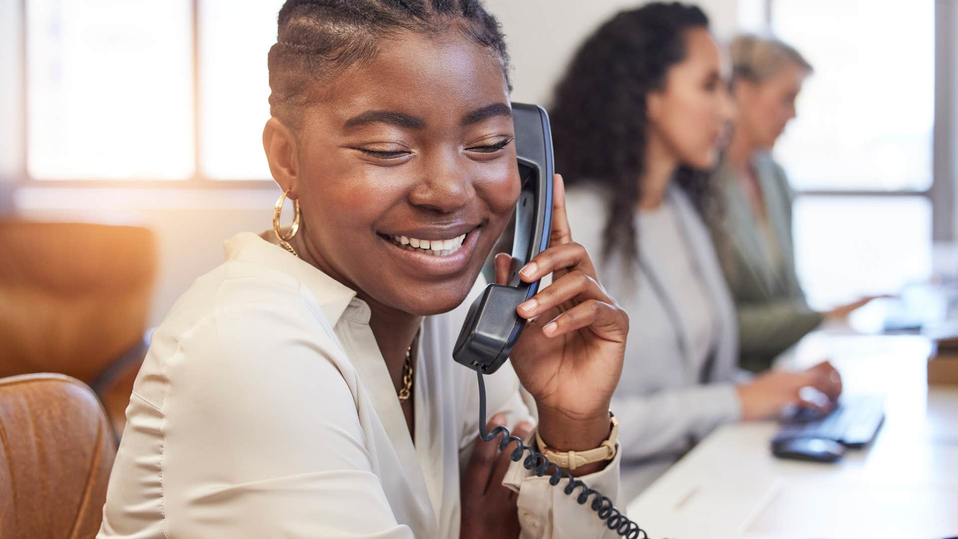 woman speaking on landline phone