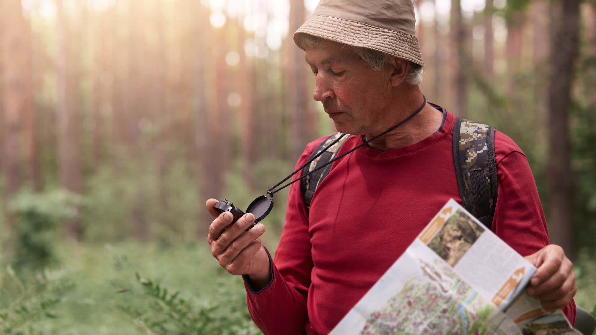 man using map in woods