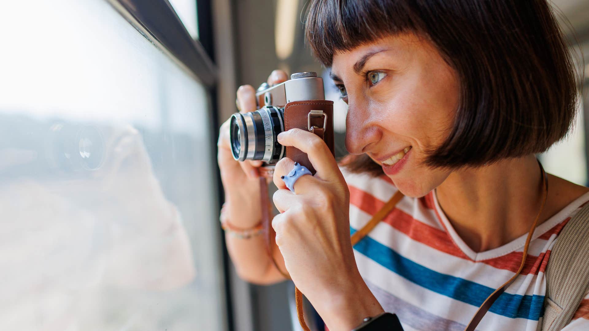 woman taking photo with film camera