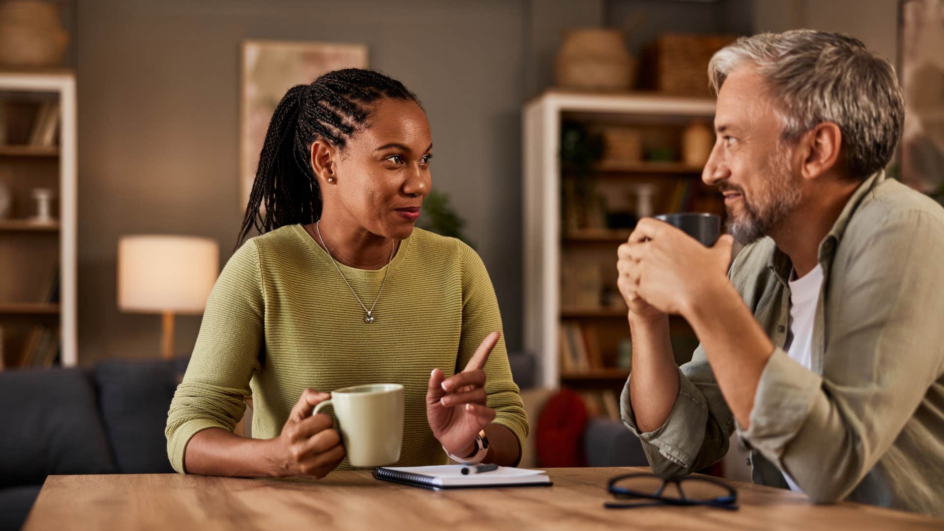 if someone who doesn't like you is too polite to admit it, they'll start saying these things casually you really have a unique approach couple deep in conversation enjoying a comforting drink