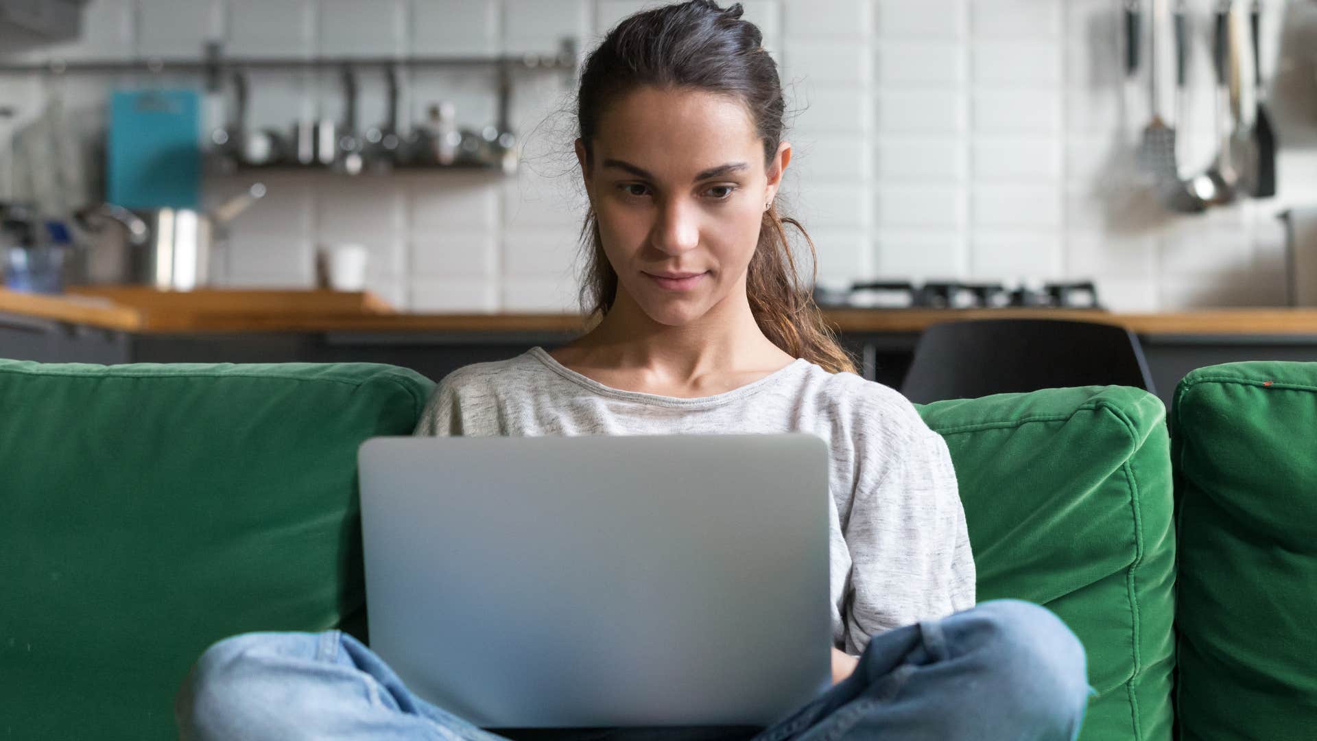 Woman using her couch as a second office.