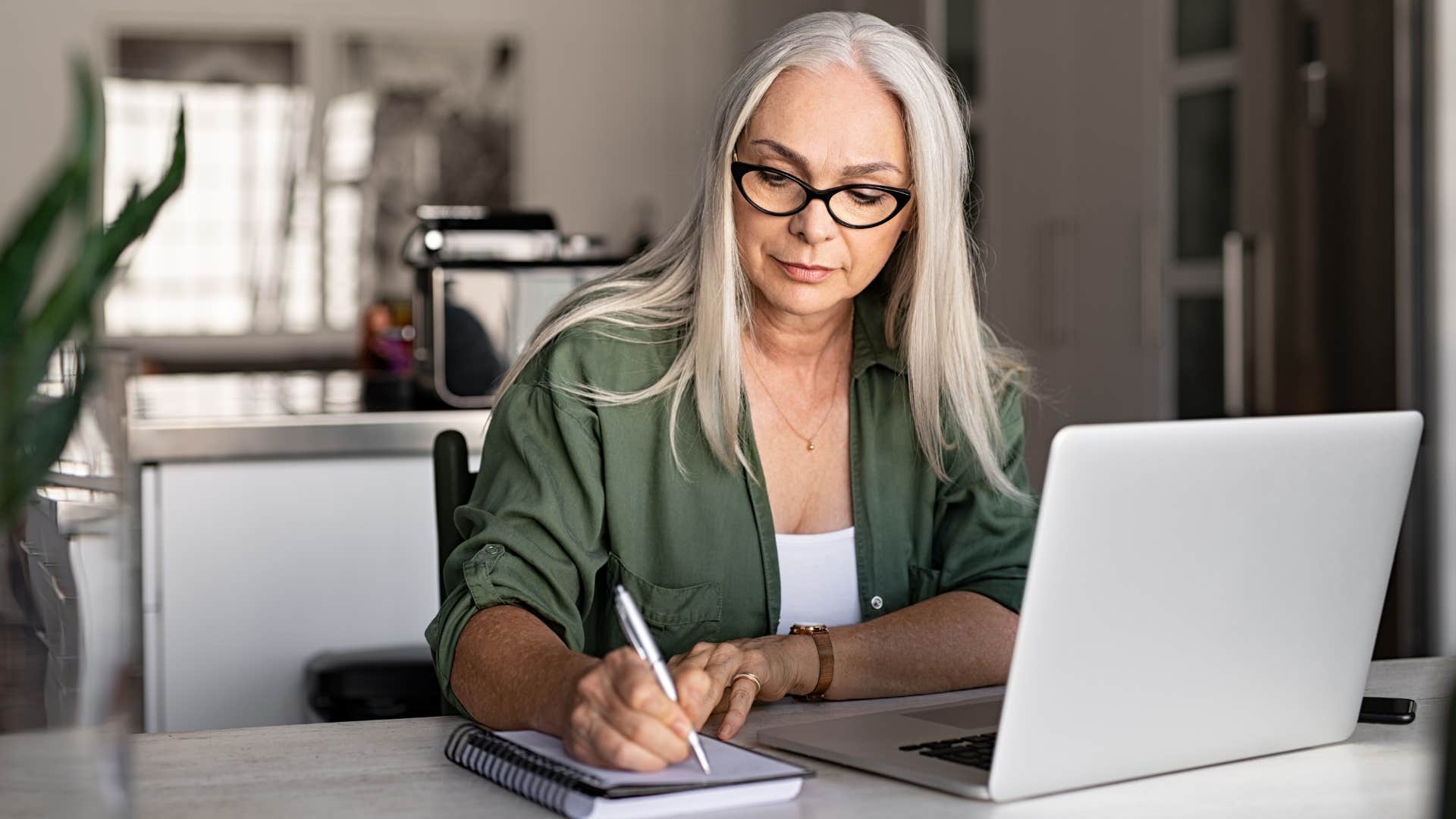 Woman whose work stuff is scattered in every room sitting at home.