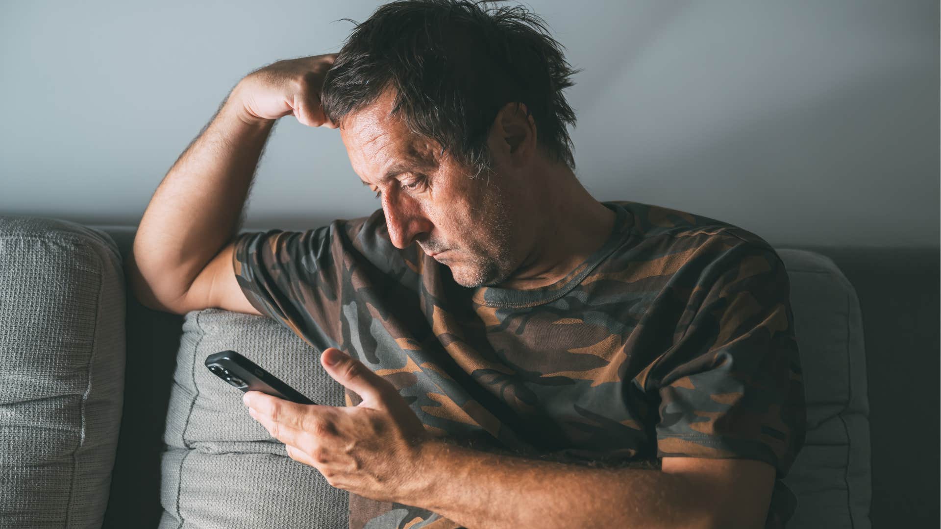 man doomscrolling on his phone at home