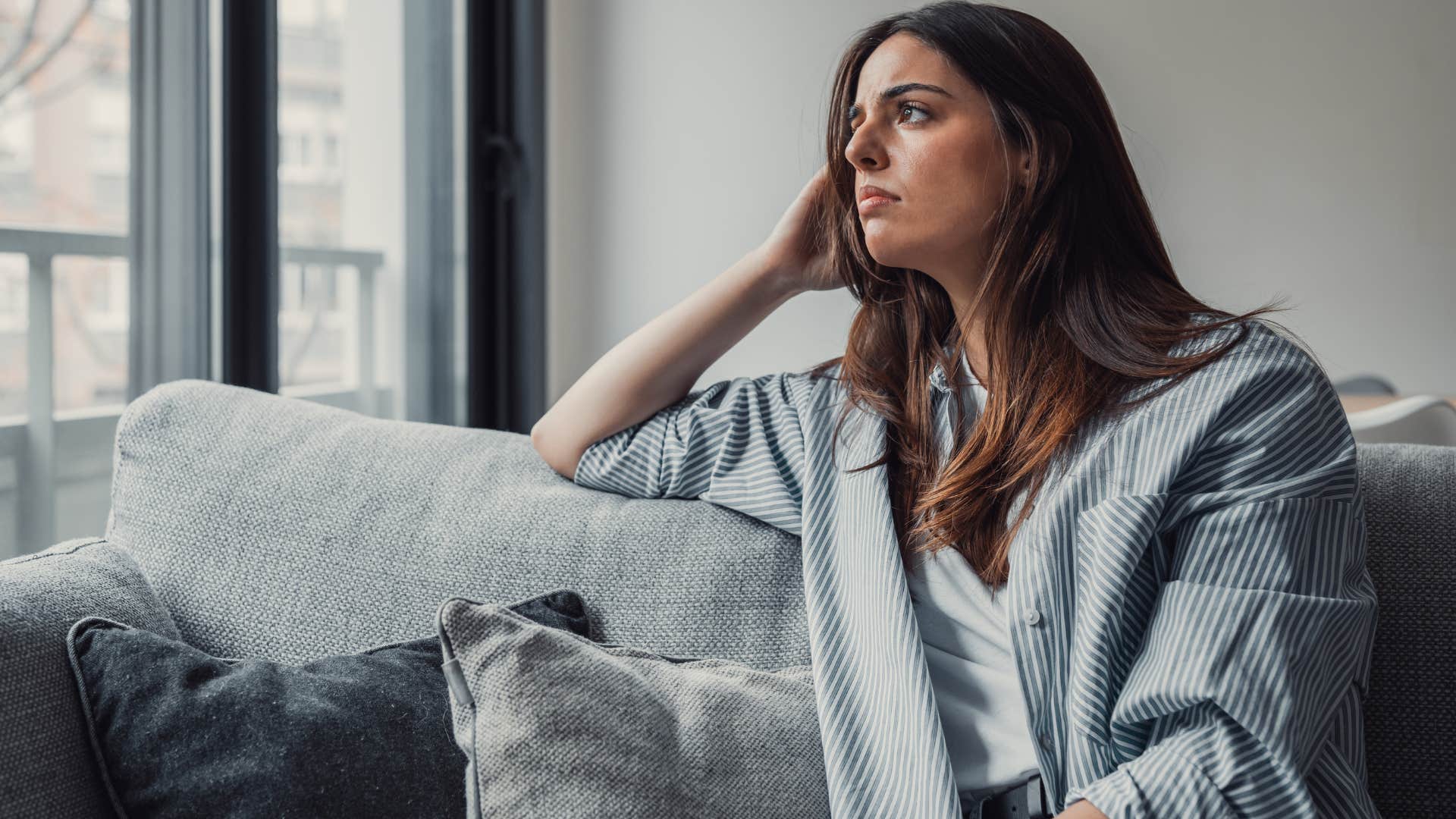 woman dreading plans she was excited about sitting at home
