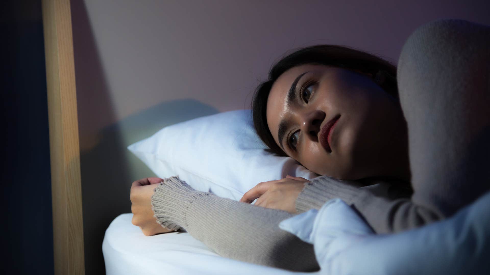 woman sleeping more than normal lying in bed