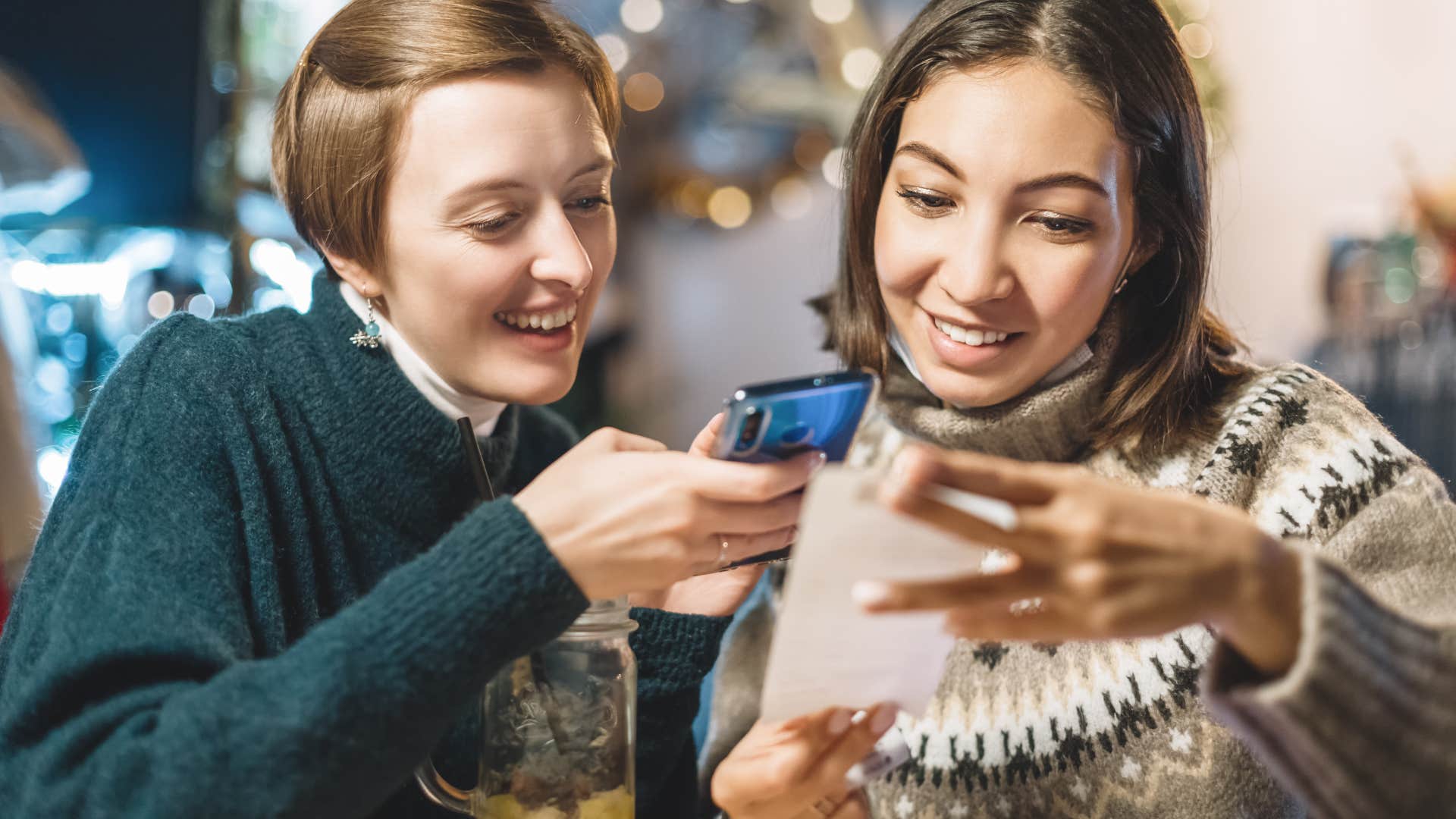 woman paying bill at restaurant with friend