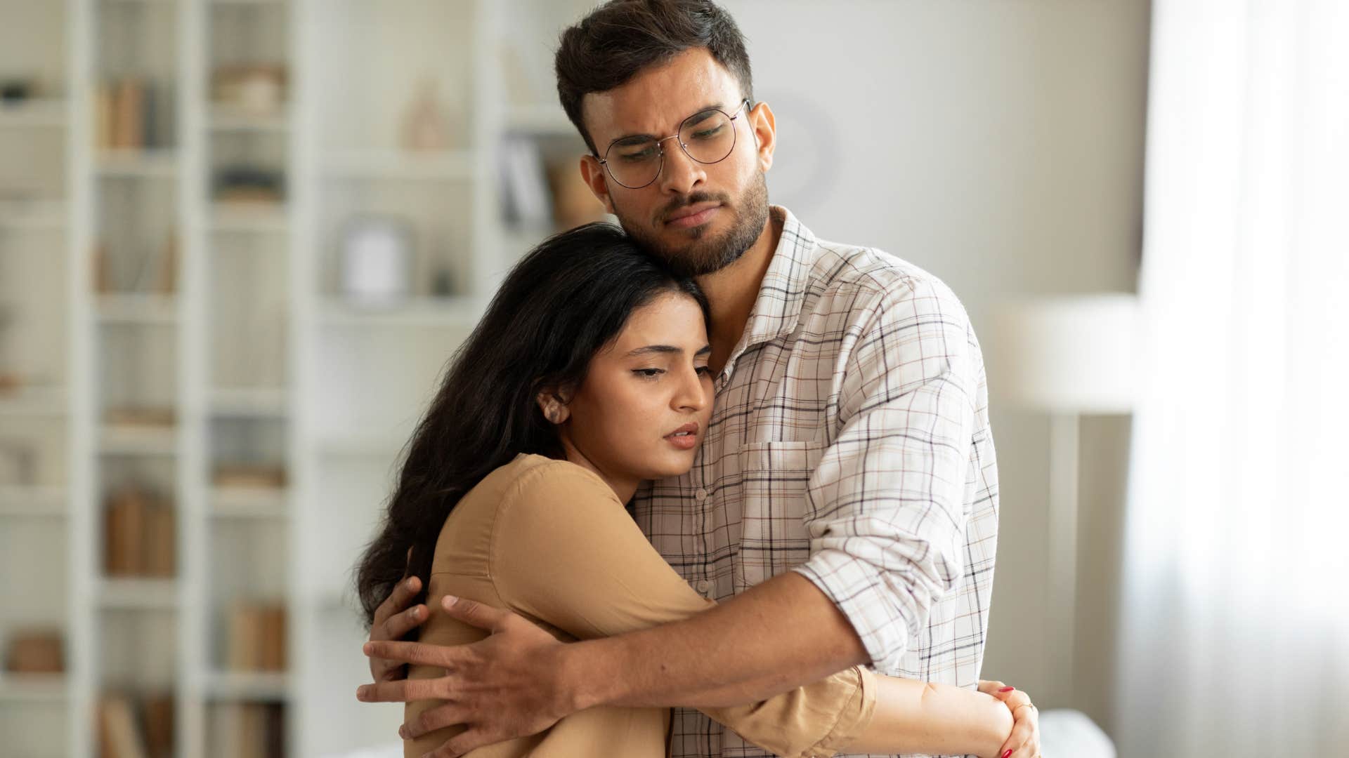 woman hugging husband saying i forgive you